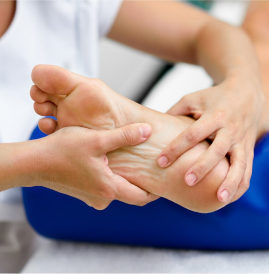 Doctor’s hands examining a patient’s foot.