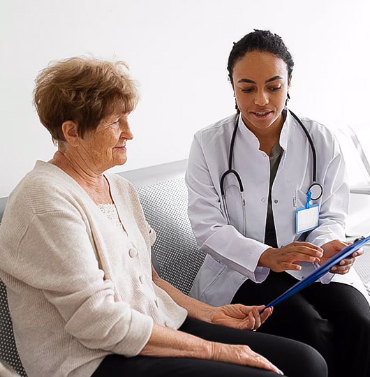 Primary care 2 Female doctor reviewing test results with an elderly patient.