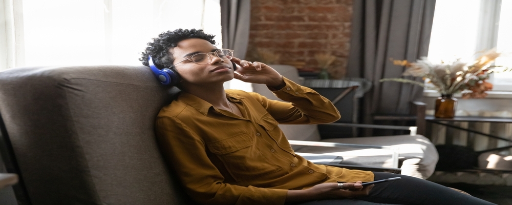 Music therapist leading a dementia patient in a personalized music session using headphones to stimulate memory and emotional connection